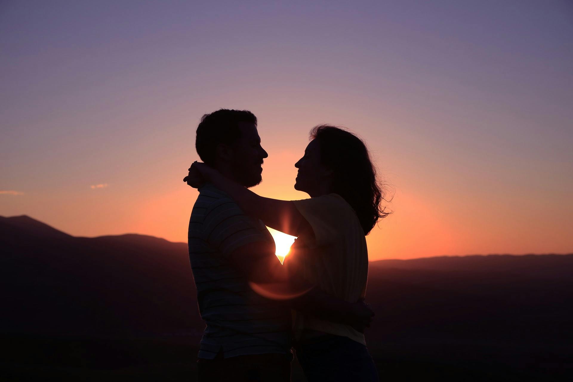 Man and woman embracing at sunset - Photo by Oziel Gómez on Unsplash - for post How to Write About Love