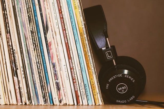 Headphones and vinyl on shelf - Photo by blocks at Unsplashh