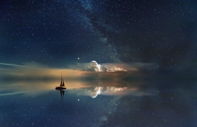 boat on water with night reflection - Photo by Johannes Plenio on Unsplash