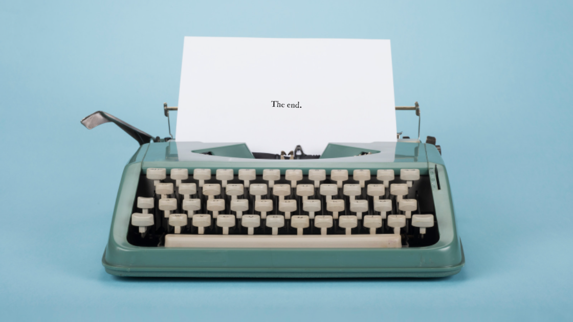 A manuscript after the story resolution with a page in a blue typewriter that says "the end"