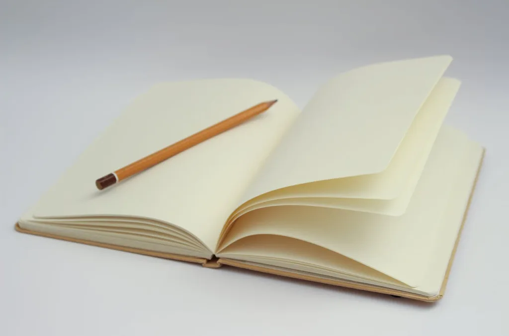 Picture of open blank notebook with a pencil inside, ready for novel planning - Photo by Dom J for Pexels